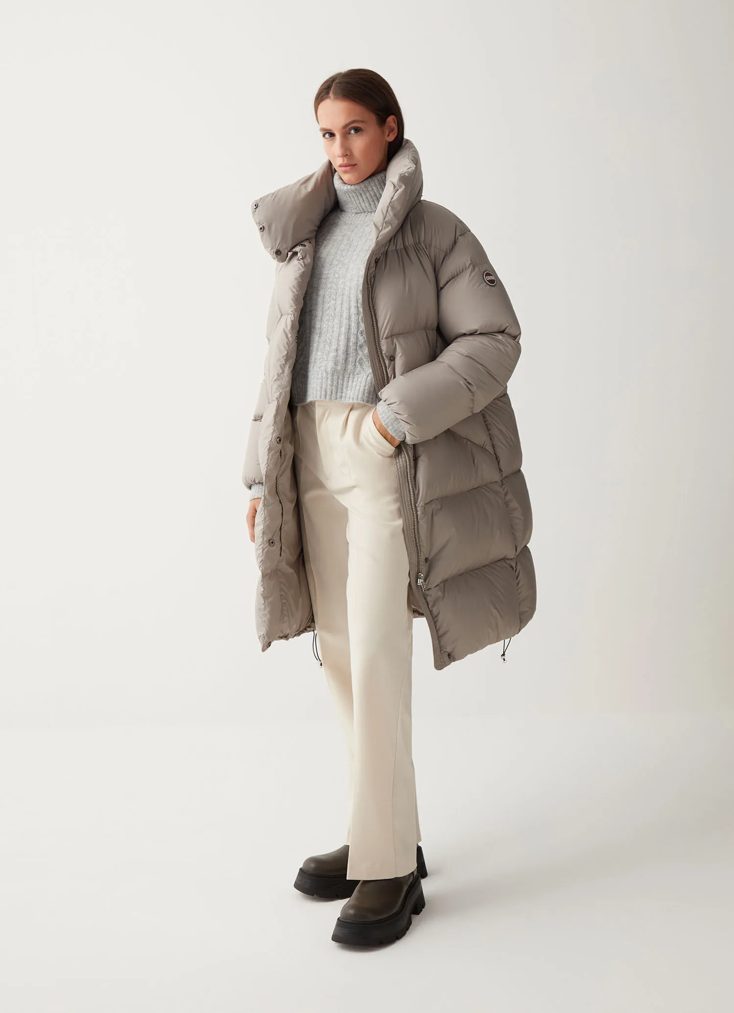 Full-length oversize quilted down jacket with drawstring at the hem