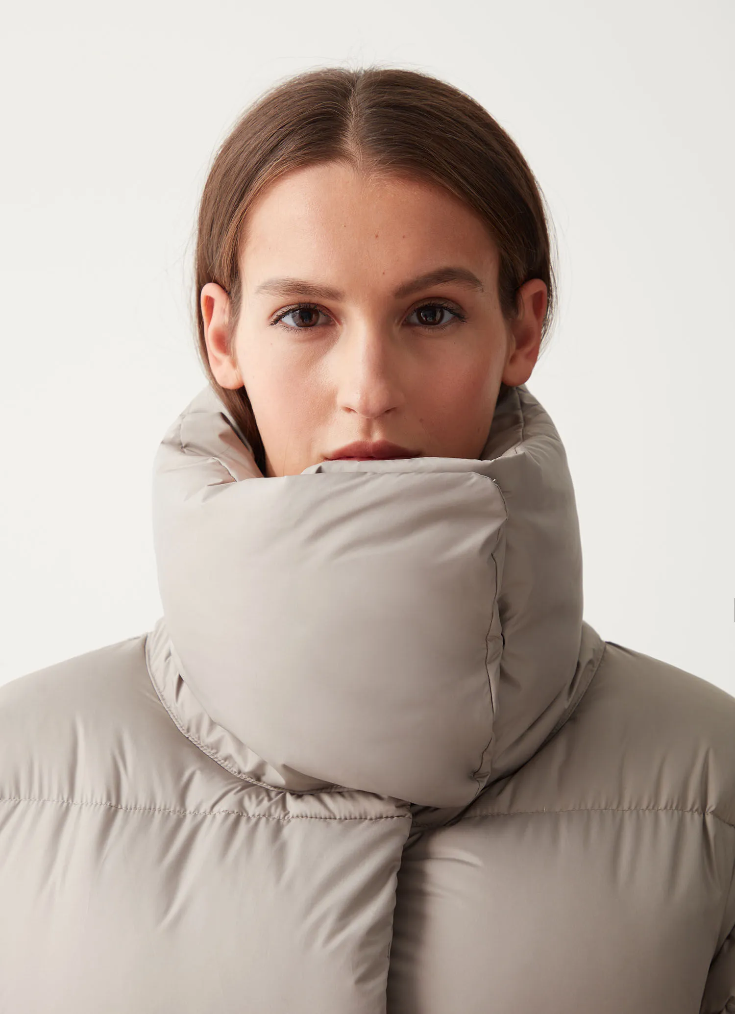 Full-length oversize quilted down jacket with drawstring at the hem